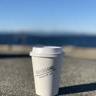 a cup of coffee on the pavement