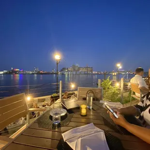 a woman sitting at a table with her cell phone