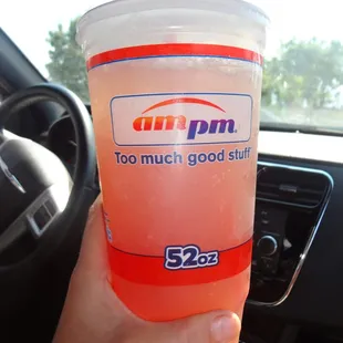 a person holding a drink in their hand