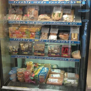 a refrigerated display case filled with food