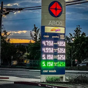 a gas station sign at dusk