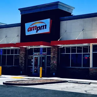 the front of a building with a sign that says ampm