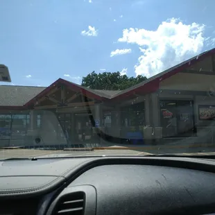 a view of a restaurant from inside a car