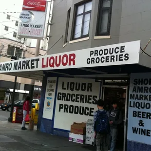 a man standing in front of a liquor store