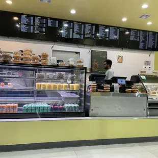 a bakery counter with a variety of food items