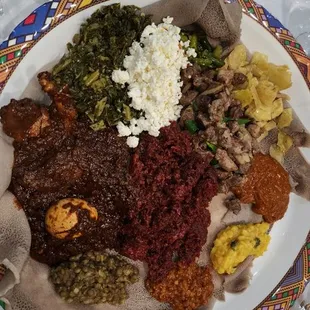 Vegetarian combo, Tibs ( Sauteed Beef), Doro Qey Wot (Chicken Stew),  Kitfo (Steak Tartar) Regular Shiro, Shiro Bedist, Cottage Cheese.