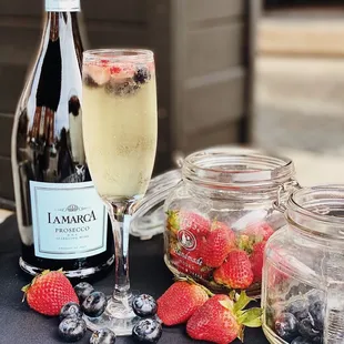 a glass of wine and a bottle of champagne