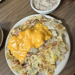 Their infamous trash potatoes with scrambled eggs and a side of sausage gravy. Expect to take a to-go box.