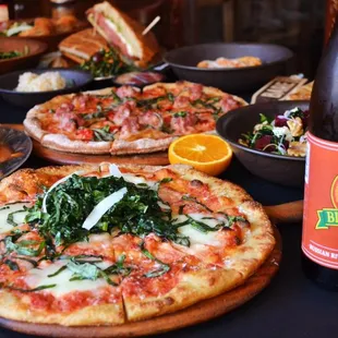 a table full of pizzas and beer