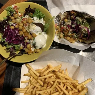 a plate of fries and a bowl of salad