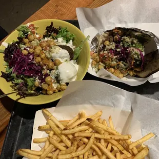 a plate of fries and a bowl of salad