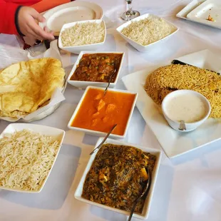 A lamb curry, chicken tikka masala, and paneer tikka (I think) with bhatura
