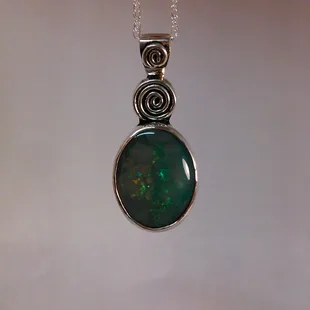 An opal pendant.  The Design was inspired by Van Gogh's 'The Starry Night'.