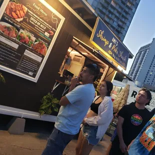 Night crowd gathering at Amy&apos;s Shrimp and Poke Shack