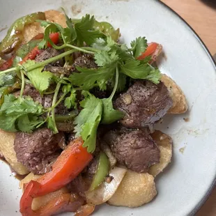 Garlic butter filet mignon - 6 oz filet mignon cut into cubes, served with Asian chimichurri, fried sticky rice.