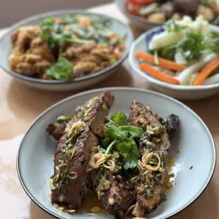 Grilled Pork Ribs - Slow-braised pork ribs with chimichurri, scallion oil, and crispy shallots.
