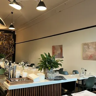 a dining room with a bar and chairs