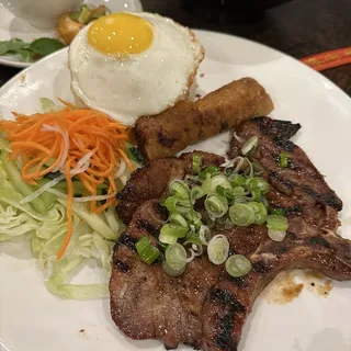 23. ( Grilled Porkchop Combo Over Rice)Com Suon, Cha Gio, and Trung