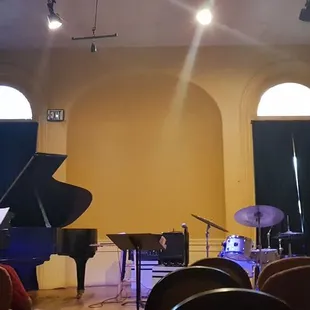 a stage with a piano and a piano player