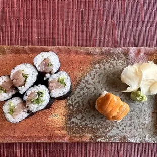 a plate of sushi and rolls