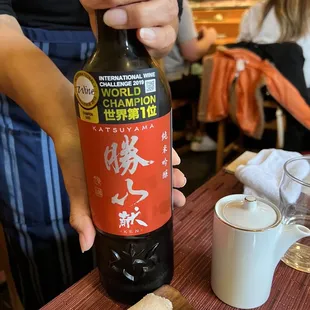 a person holding a bottle of beer