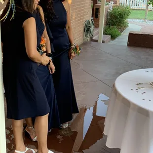 Cake photos and wedding cake cutting while standing in a giant puddle of leaking water.