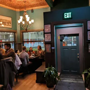 people sitting at tables in a restaurant
