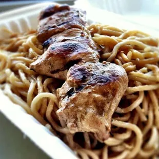 Pork skewer with a box of An's famous garlic noodles.