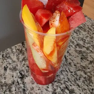 a bowl of fruit and ice cream