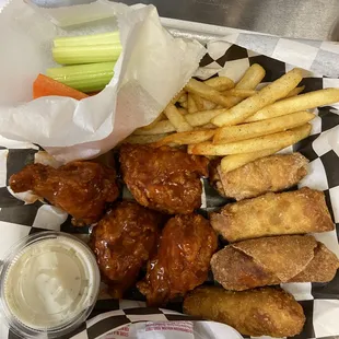 a basket of chicken wings and french fries