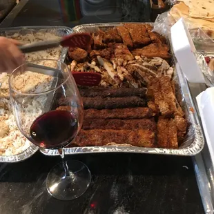Meat portion of platter includes multiple chicken and beef dishes and enough food to feed a large group with leftovers. Wine not included (: