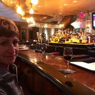 a woman sitting at a bar