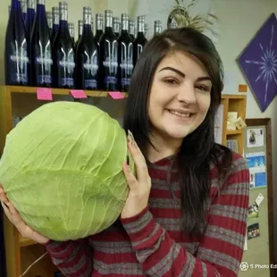 a woman holding a cabbage