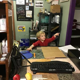 Kai at the checkout counter - best volunteer yet