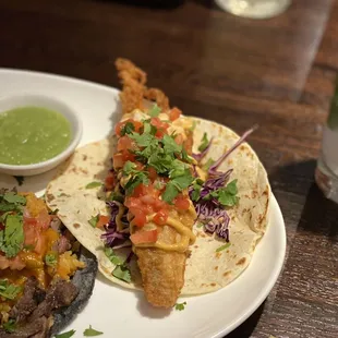 a plate of tacos and a bowl of guacamole