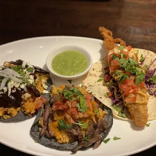 a plate of tacos and a bowl of guacamole