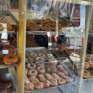a variety of donuts in a display case