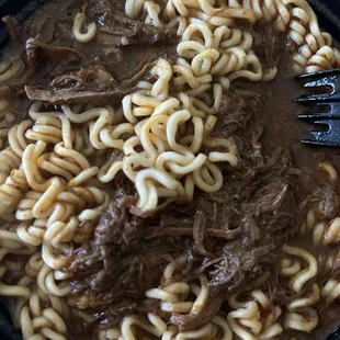 Birria ramen. Served with onions, cilantro and limes on the side. Good flavor but too salty for my taste.