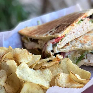 a sandwich and chips in a basket