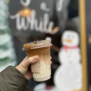 a hand holding a cup of coffee