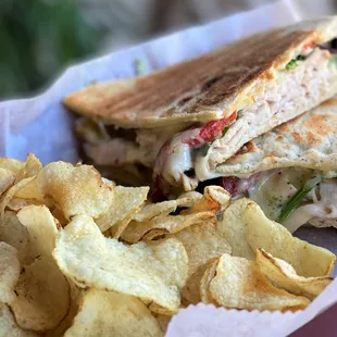 a sandwich and chips in a basket