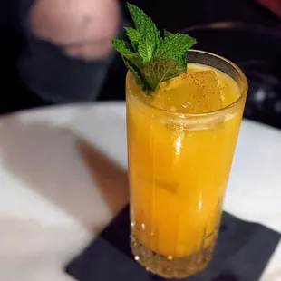 a glass of orange juice on a table