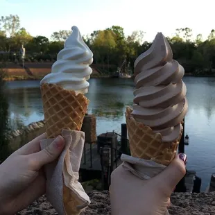 two people holding ice cream cones