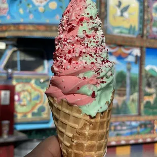a hand holding an ice cream cone