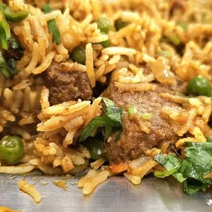 Tender pieces of lamb buried under rice