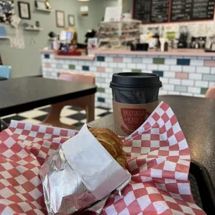 a cup of coffee and a croissant