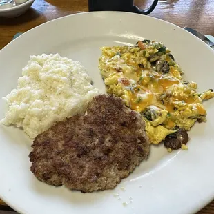 Country sausage homemade with loaded scrambled eggs and grits.