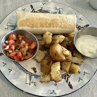 Breakfast burrito with home fries, pico de gallo and sour cream.
