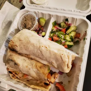 Chicken shish wrap with side salad of tomato and cucumber and yogurt dill sauce and unknown other sauce (maybe olive based?)
