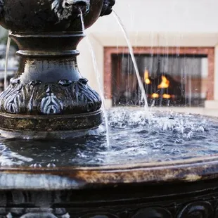 water fountain next to the fireplace